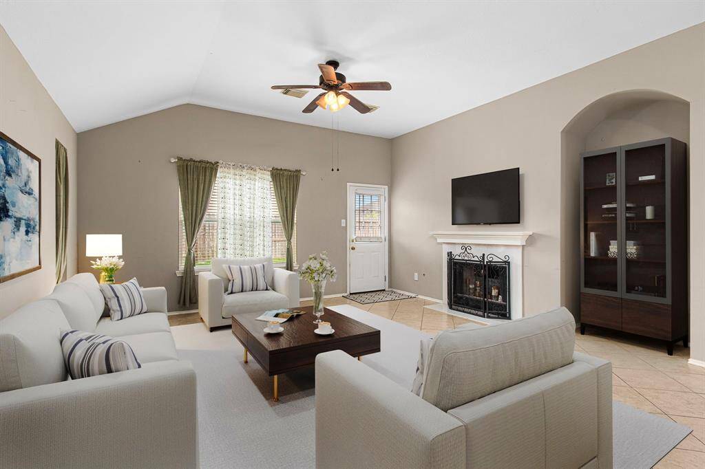 The living room boasts a gas fireplace, arched entertainment niche and high ceilings. Infused with natural light, this spacious room with neutral color scheme is ready for you to put your personal touch on it. Room for your sectional? Absolutely!