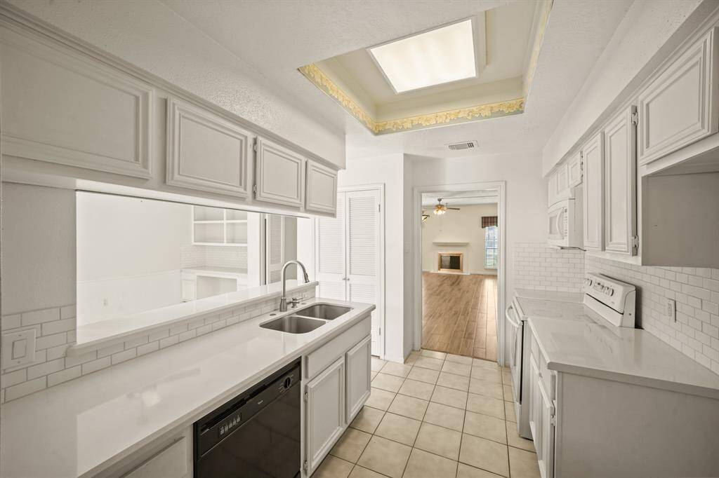 Crisp white cabinets provide a clean and timeless look, enhancing the sense of brightness and openness in this space.