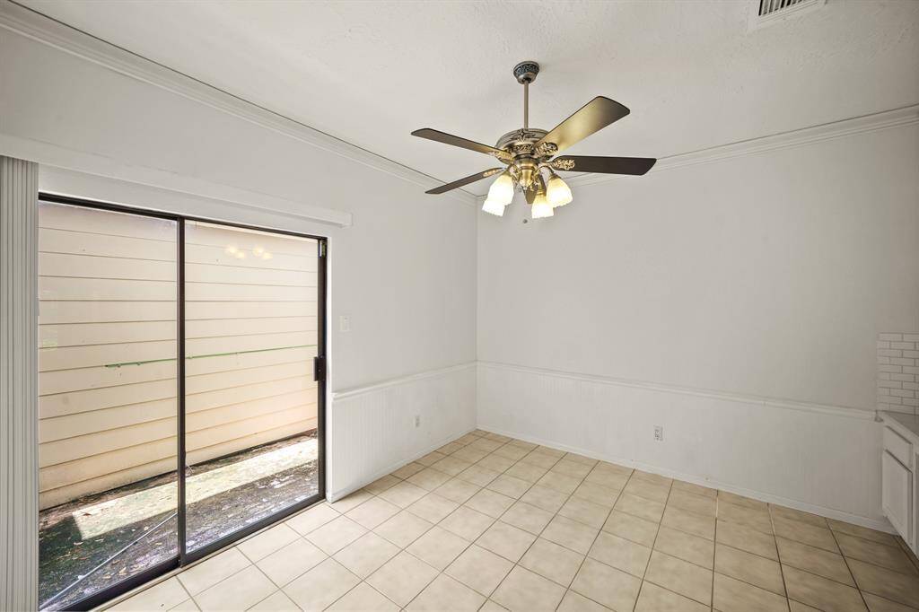 The breakfast room opens to the back patio through sliding glass doors, inviting natural light and offering easy access to outdoor dining and relaxation.