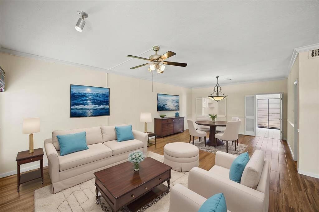 Upon entering the townhome, you're welcomed into a spacious living area that seamlessly flows into the breakfast room and kitchen, creating an open and connected layout perfect for everyday living and entertaining. - virtually staged