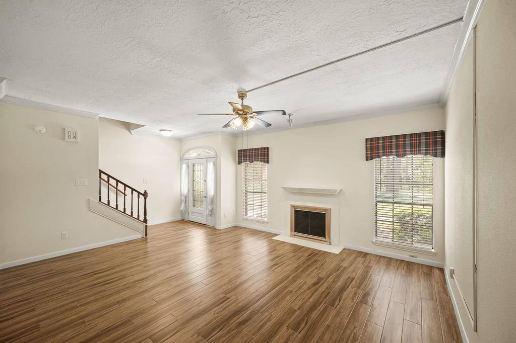 A centrally located wood-burning fireplace adds warmth and charm to the living area, creating a cozy focal point for relaxing or entertaining.