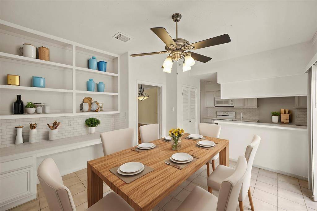 The breakfast area offers a cozy spot for casual dining and features additional built-in cabinetry and a convenient desk space, perfect for extra storage or a home workspace. - virtually staged