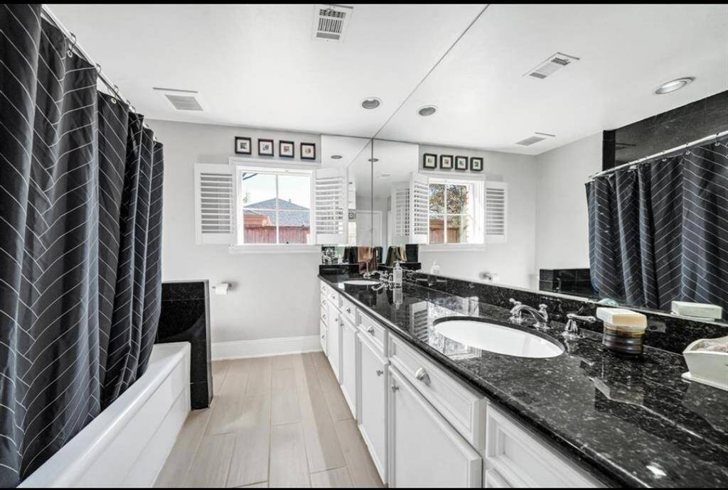Step into the master bathroom, feature black granite countertops that add a touch of modern luxury