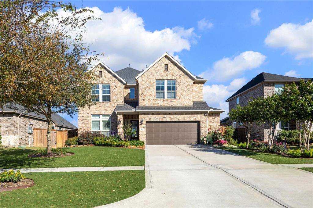 Lush, landscaping enhanced by outdoor landscape lighting,creates a welcoming and vibrant curb appeal.