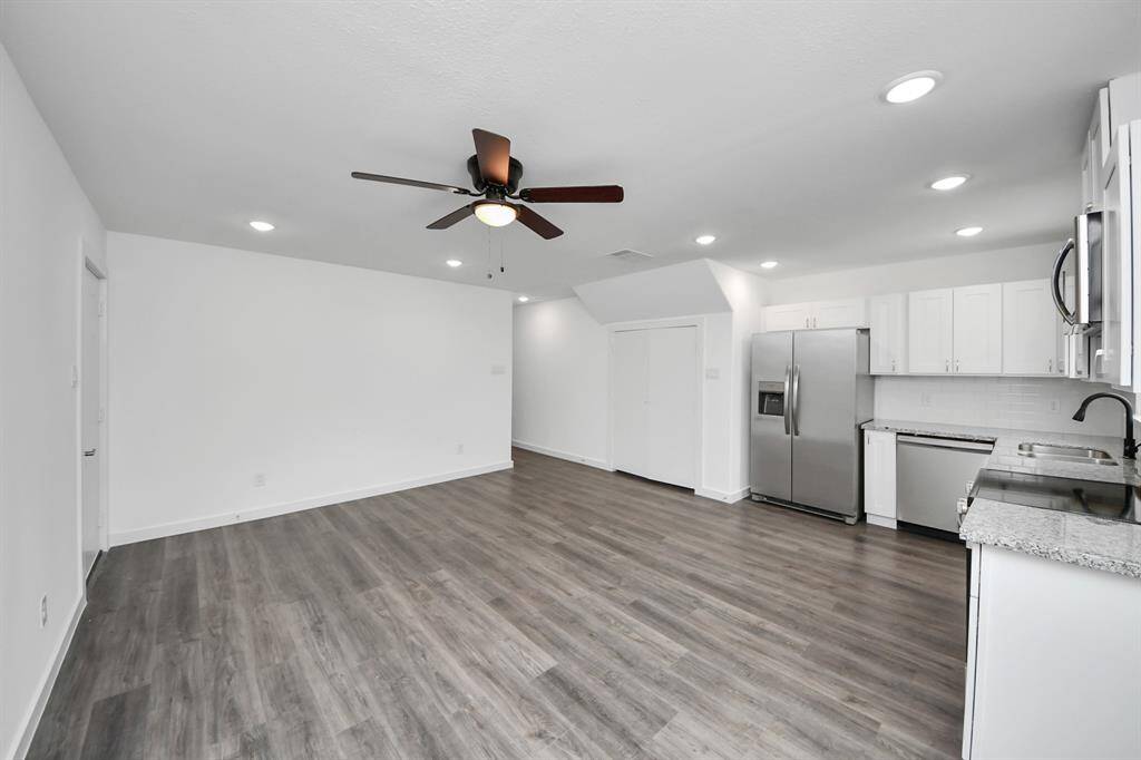 Living room features a ceiling fan and recessed lighting.