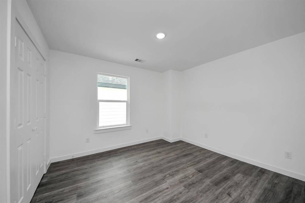 Third bedroom features recessed lighting and a large window.