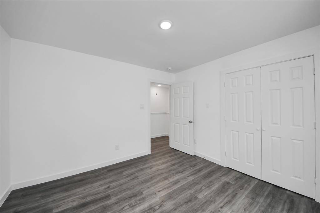 Third bedroom features recessed lighting and a large window.