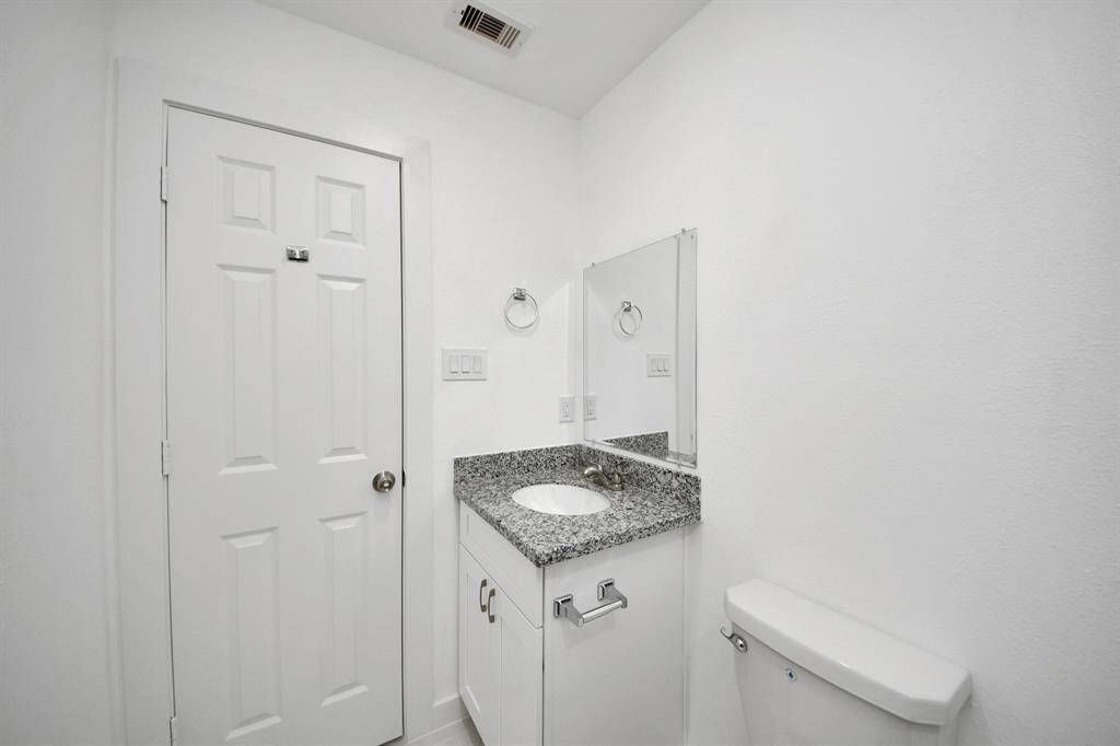 Secondary bathroom features a tub and shower combo with tile surround.