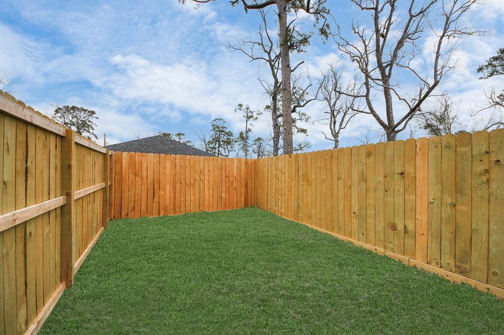 The backyard has plenty of green space.