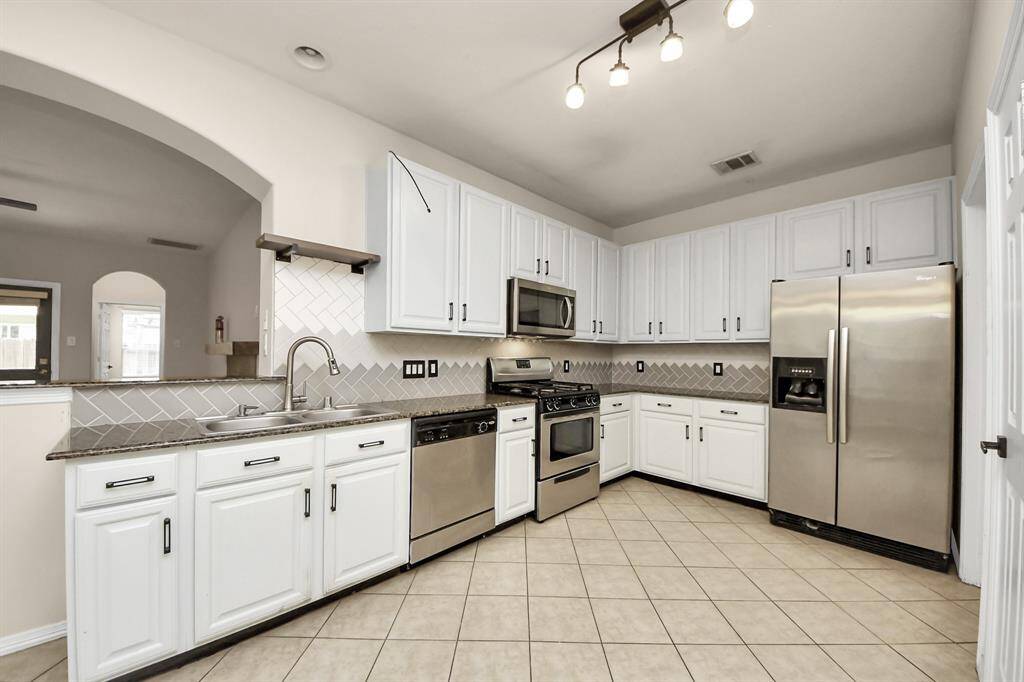 The spacious kitchen is ideal for both cooking and entertaining.