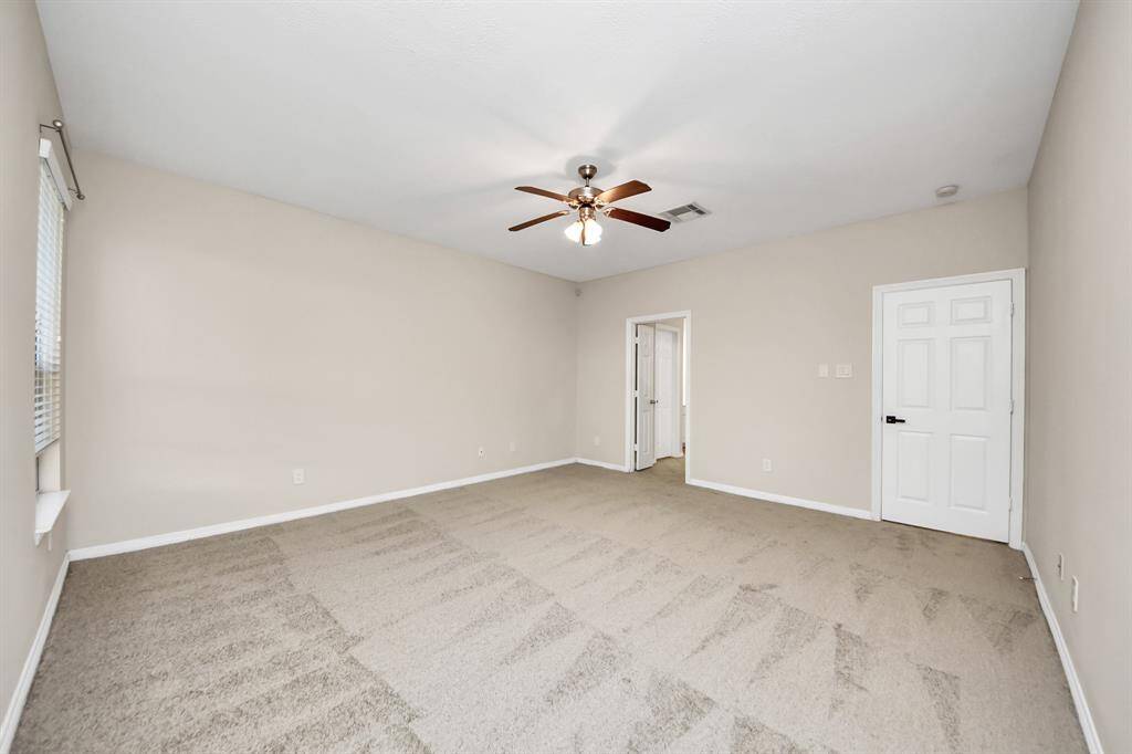 Spacious primary bedroom with an open, airy feel and plenty of room to relax.