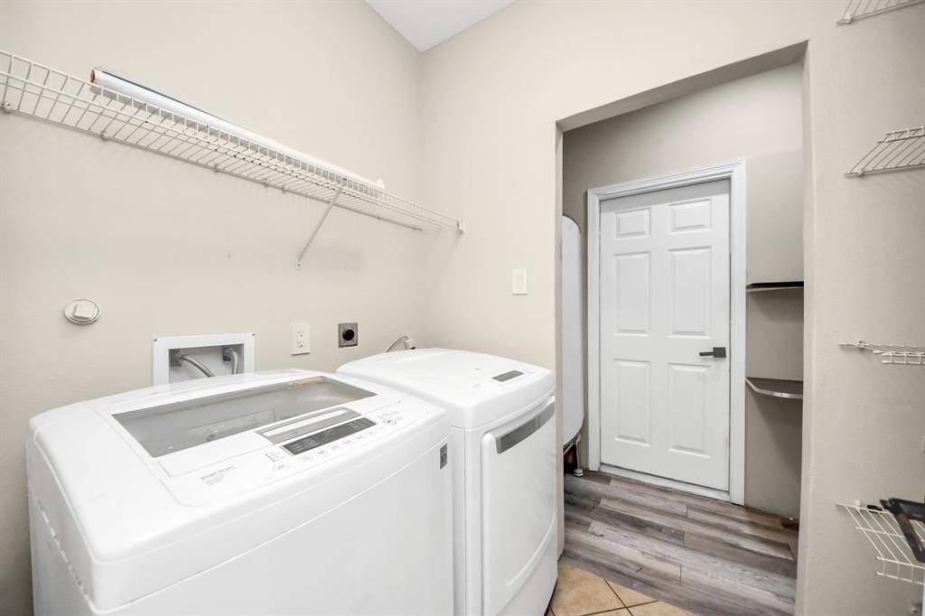 Convenient laundry room with plenty of storage and space for all your cleaning needs.