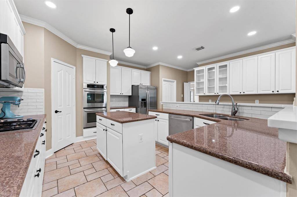 Kitchen has abundant cabinetry with a built-in workstation/desk.