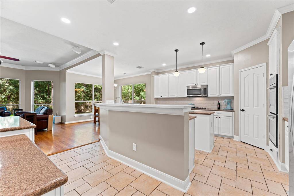 Spacious open-concept living area with abundant natural light and seamless flow between kitchen and dining spaces.