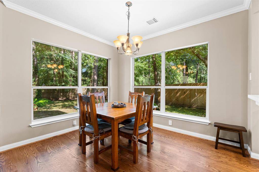 Cozy breakfast nook with stunning wooded backyard views.