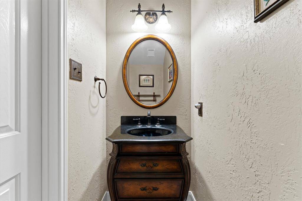 Convenient downstairs half bath with elegant fixtures.
