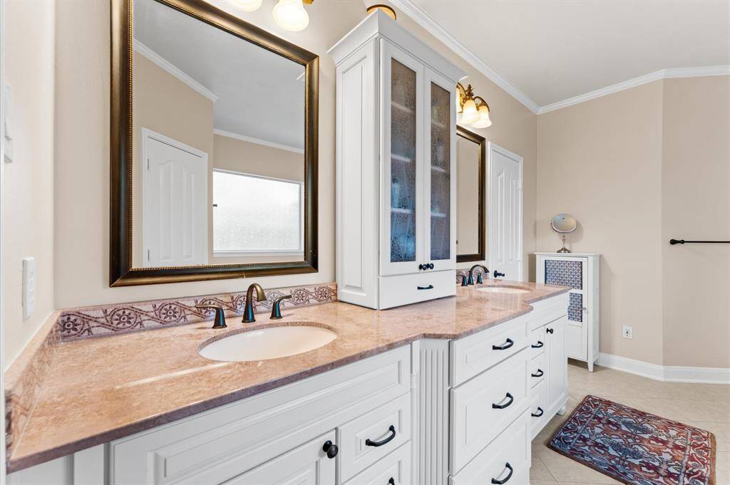Primary bathroom features double sinks and dual walk-in closets.