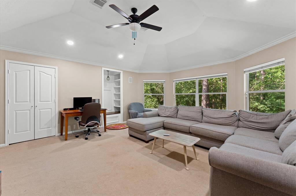 Large gameroom with stunning wooded views and a custom nook with bench storage.
