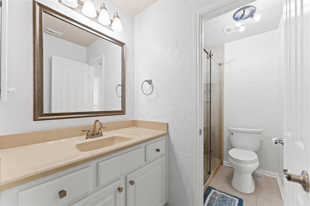 Jack and Jill bathroom offers separate vanities for added convenience.