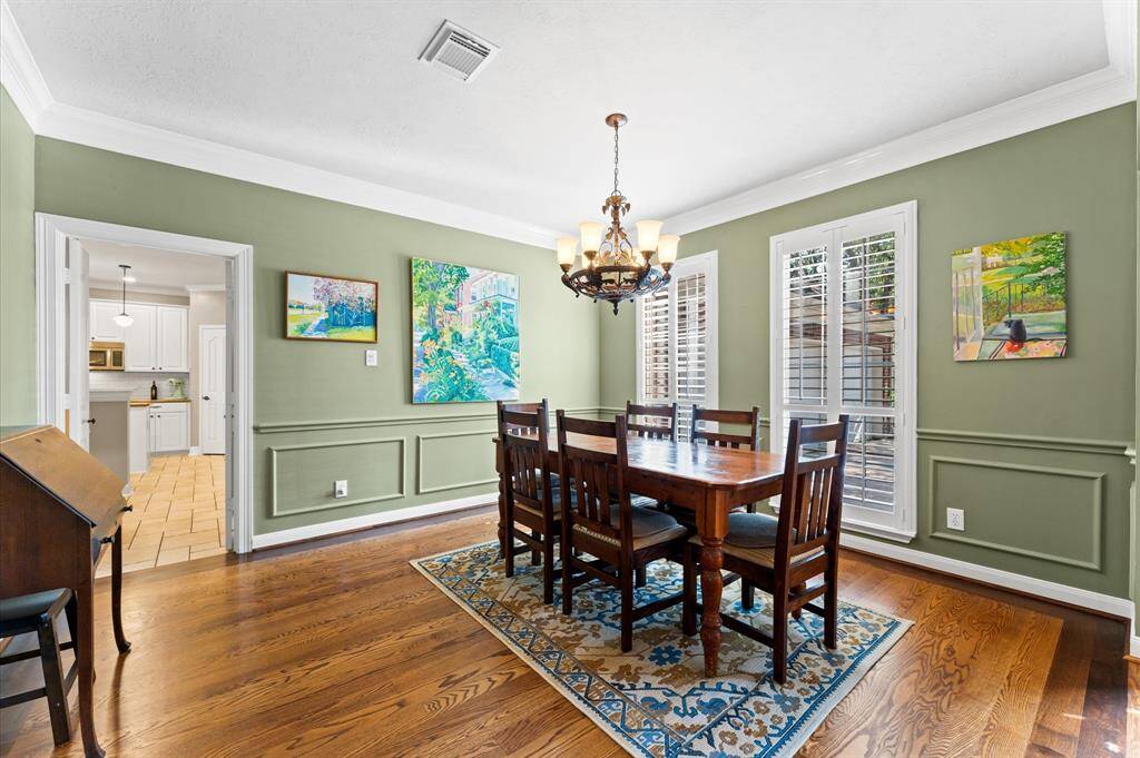 Formal dining room with plantation shutters and easy access to kitchen.