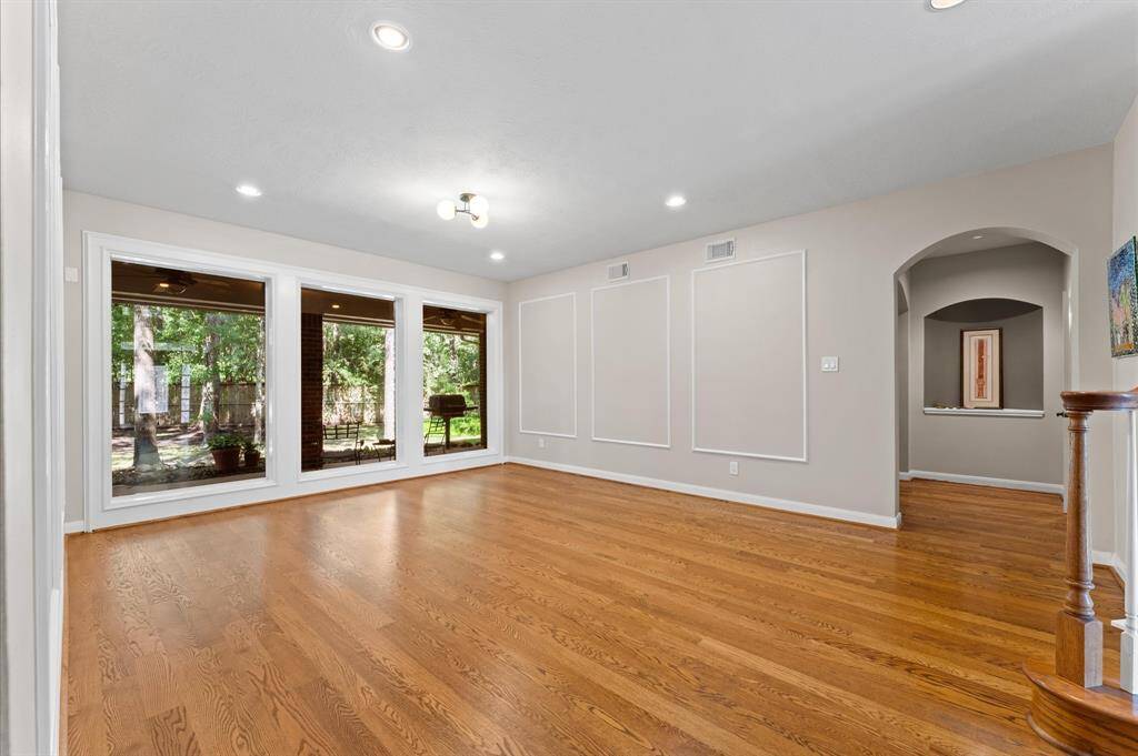 Expansive floor-to-ceiling windows and recessed lighting create a bright living space.
