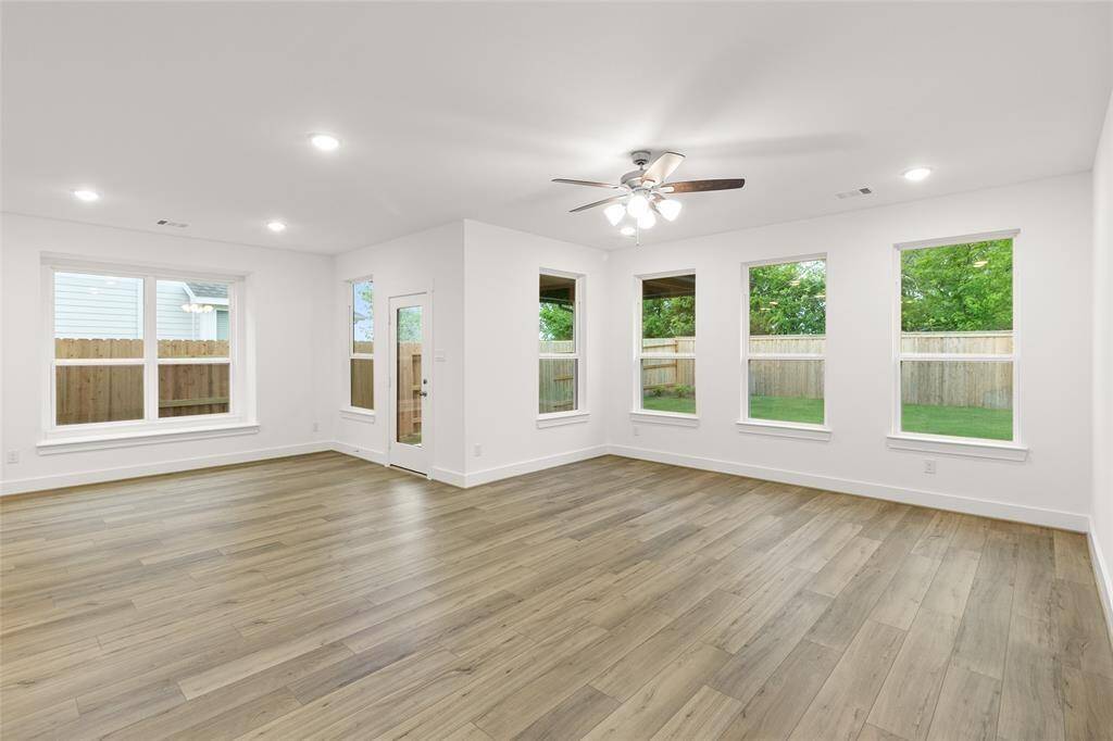 The abundance of windows not only brightens the space but also brings the outdoors in, making the whole area feel airy, warm, and full of life.