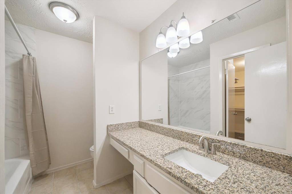 Primary bathroom, rectangle sink, brushed nickel faucet, granite counters, vanity space