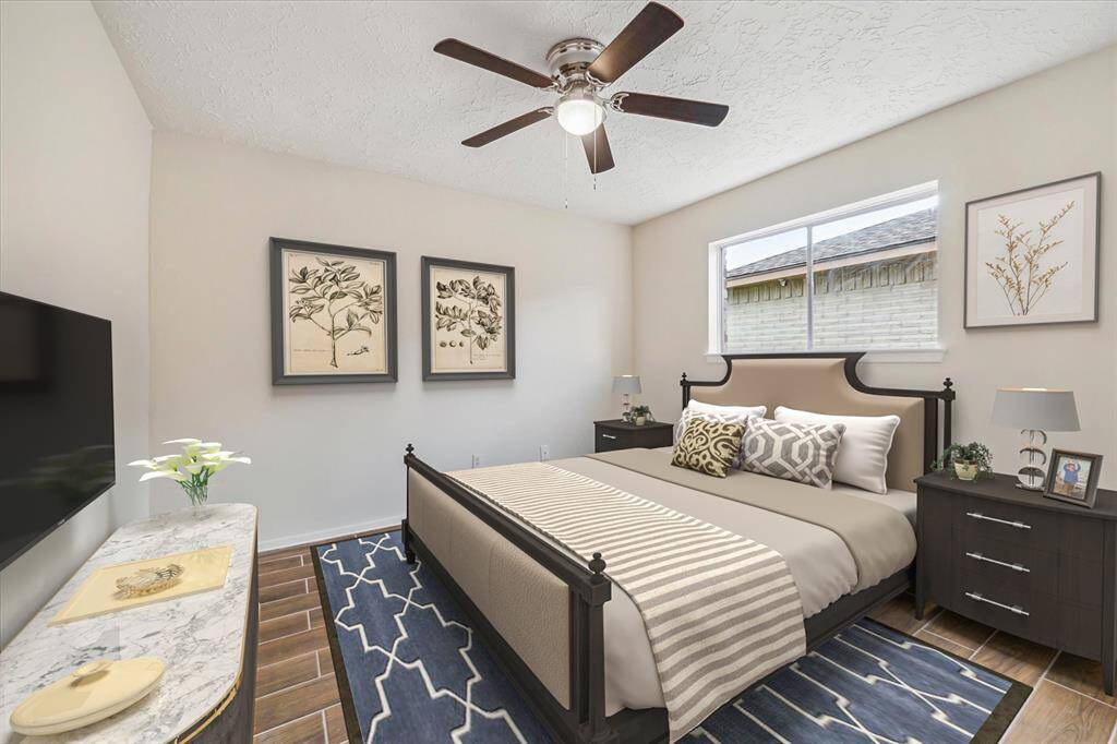 This photo is virtually staged. Secondary bedroom has wood look tile flooring. No carpet in this home.