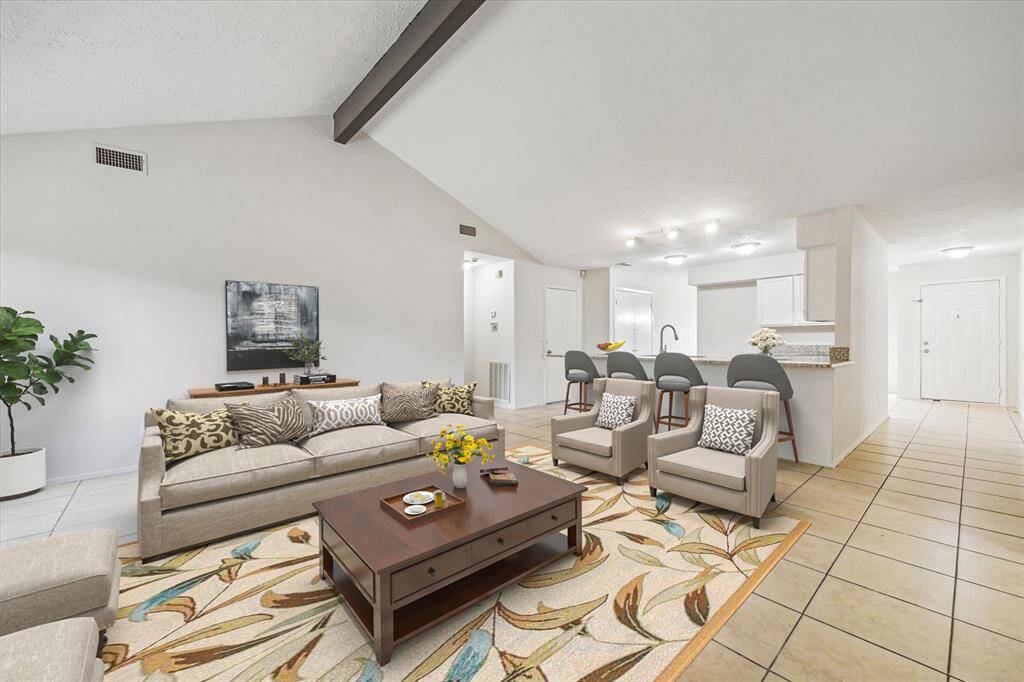 Virtual staged family room with an open floor plan to the kitchen