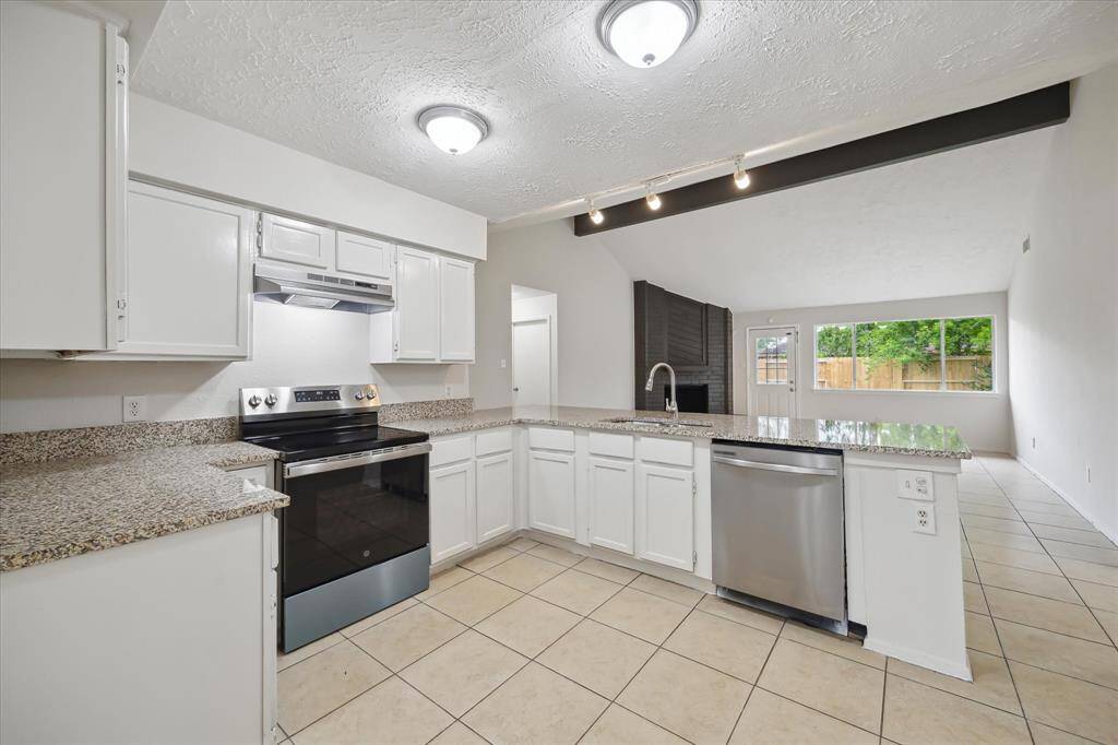 Kitchen features granite counters and stainless appliances