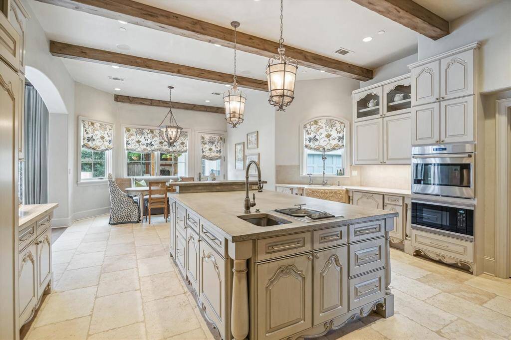 The kitchen includes two sinks, Wolf steamer and breakfast bar.