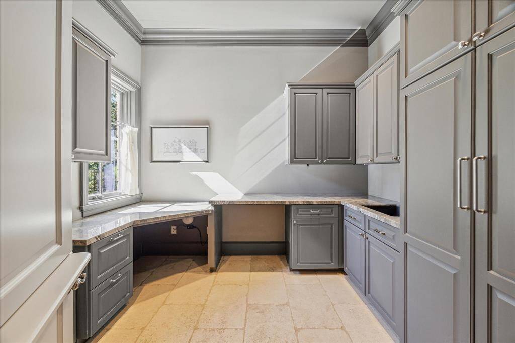 The mud room includes storage lockers, built-in desk and sink.