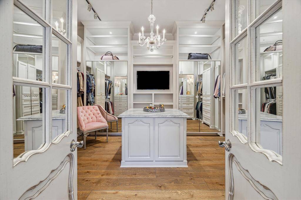 Incredible primary closet with thoughtful built-ins and central packing island.