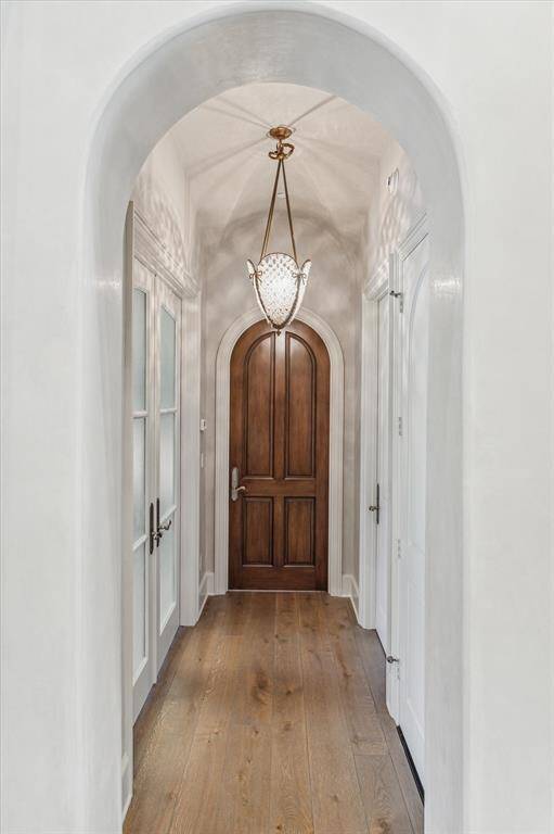 Arched hallway leading to the study down and private guest suite.