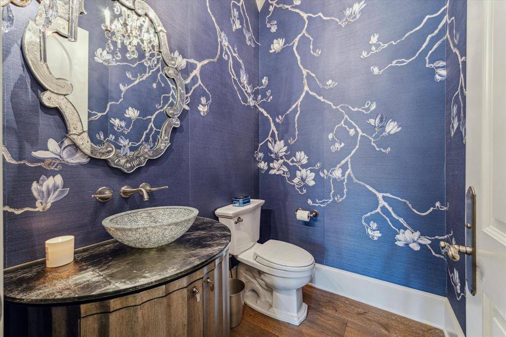 Exquisite De Gournay wallpapered powder room.