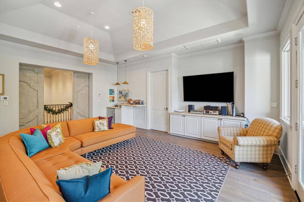 The incredible gameroom features vaulted ceiling, bar with beverage fridge and great natural light.