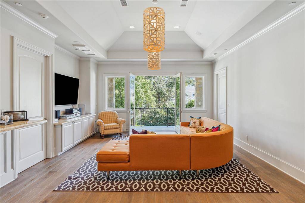 The game room opens to a balcony with stairway leading down to the back yard and pool.