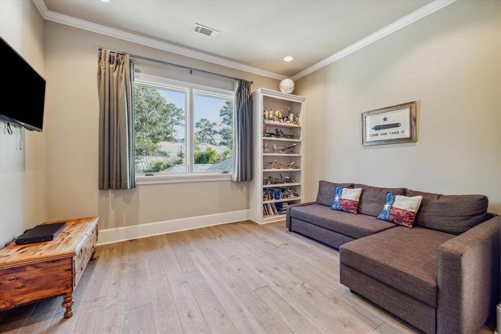 The sitting room to the first suite with built-in bookshelf and large window.