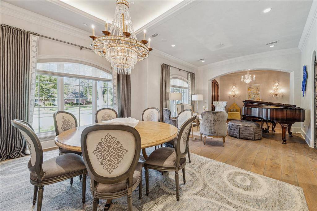 Dining room with trussed ceiling and exquisite chandelier.