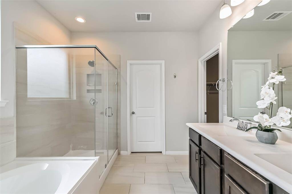 Double sinks, plus tub and shower.