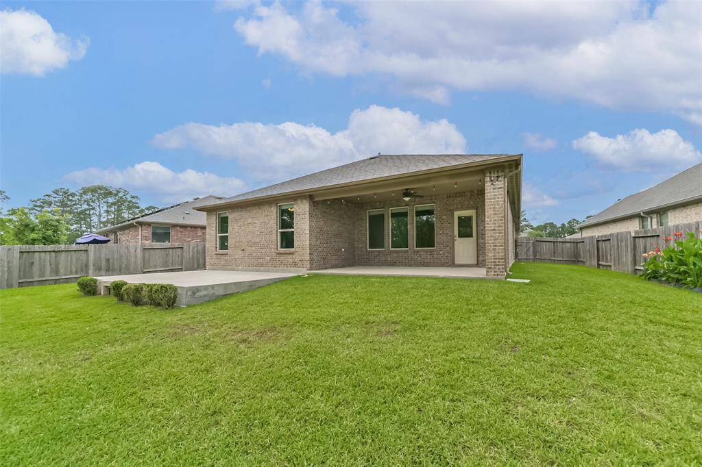 Back yard with added concrete patio area.