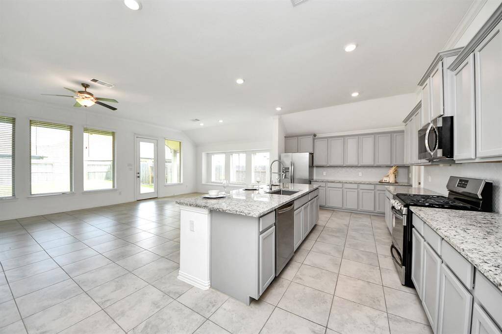 Spacious open-concept living area with abundant natural light and a sleek kitchen perfect for entertaining.
