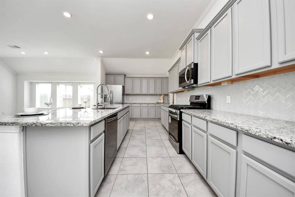 Spacious kitchen with abundant cabinetry for all your storage needs.
