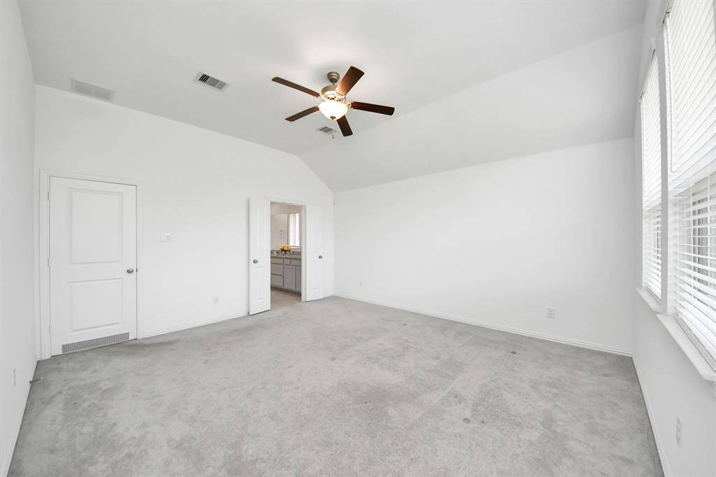 Spacious primary bedroom with a private en-suite bathroom.