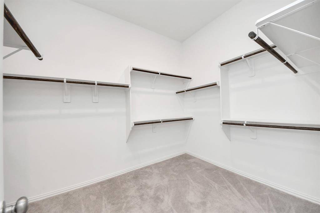 Expansive walk-in closet with abundant storage for all your wardrobe needs.