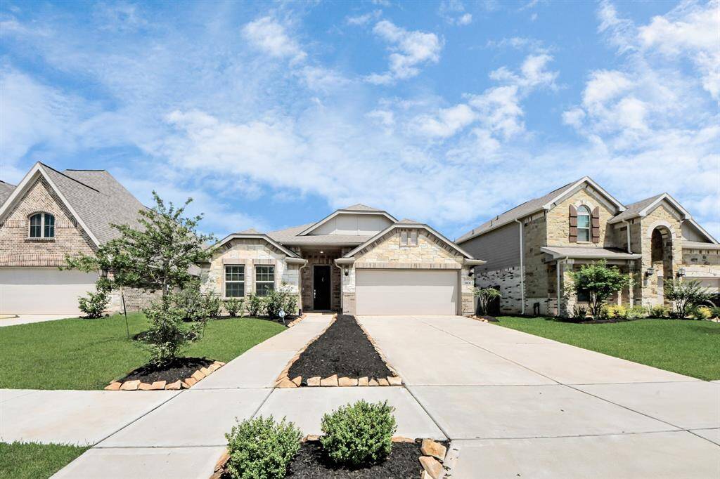 Charming home with an attractive facade and a spacious 2-car garage.
