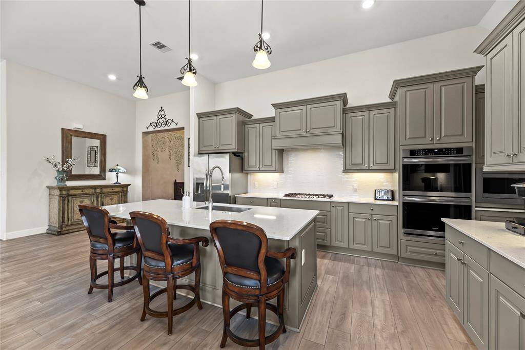 Abundant richly painted cabinetry offers both style and generous storage, adding depth and character to the space.