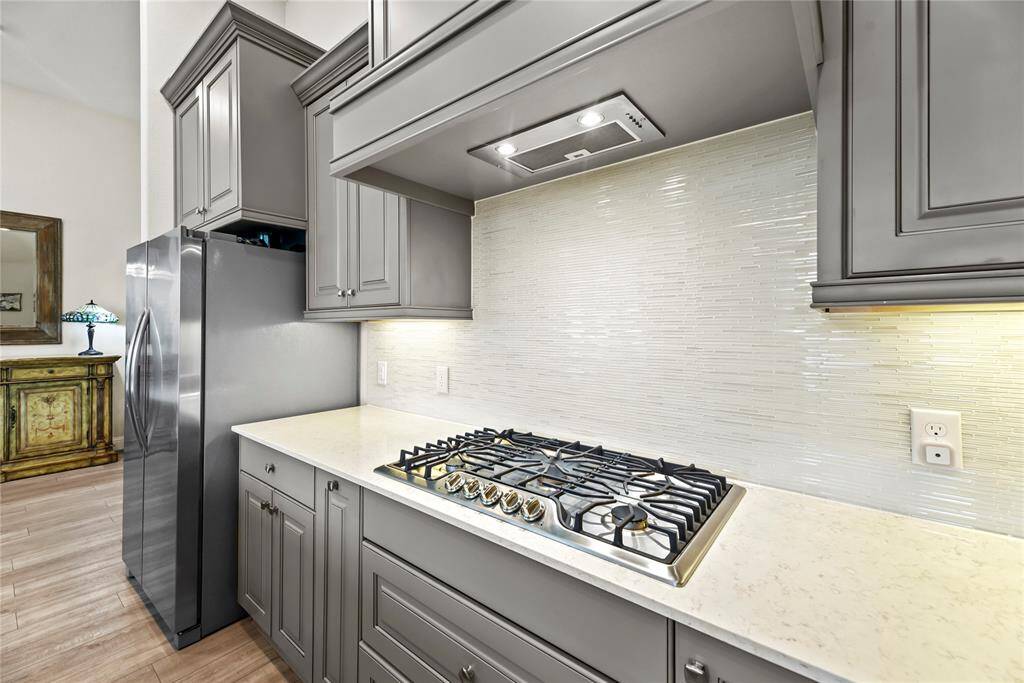 Silestone countertops paired with a coordinating backsplash not only provide a durable and elegant surface for food preparation but also add a touch of luxury and sophistication to the kitchen.
