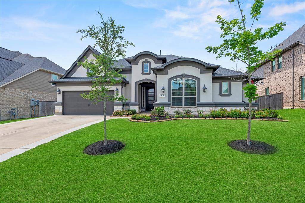 The stucco and brick exterior exudes charm and elegance, creating exceptional street appeal that captivates at first glance. Beautiful landscaping creates a warm and inviting curb appeal.