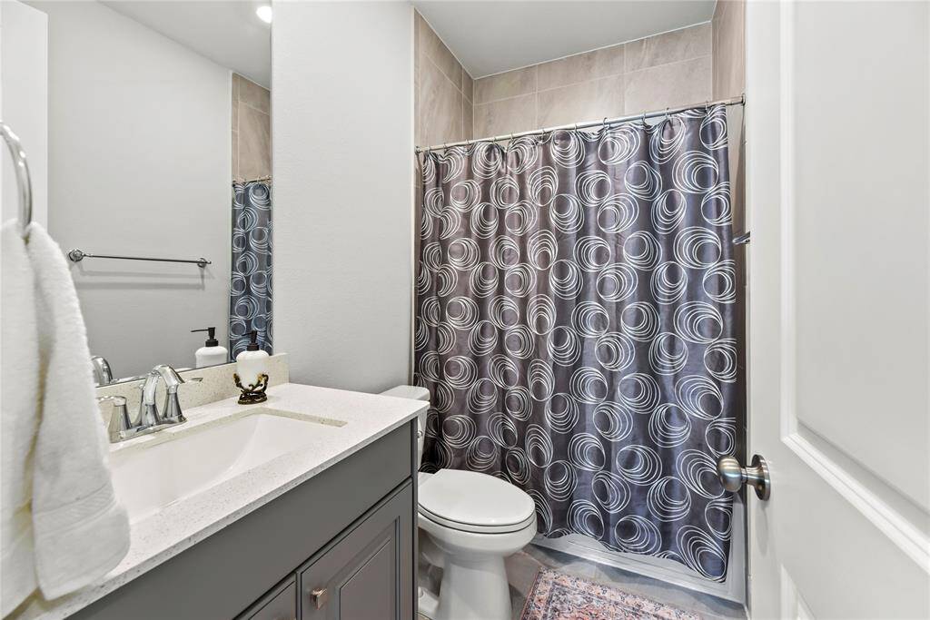 The secondary bathroom is stylishly appointed and thoughtfully designed for comfort and convenience.